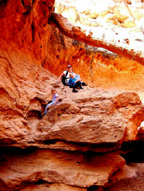 The family downclimbs one of three obstacles.