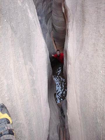 Downclimb into a pool, the crux is just below this.
